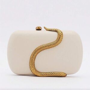 Elegant Cream Handbag with Gold Snake Accent